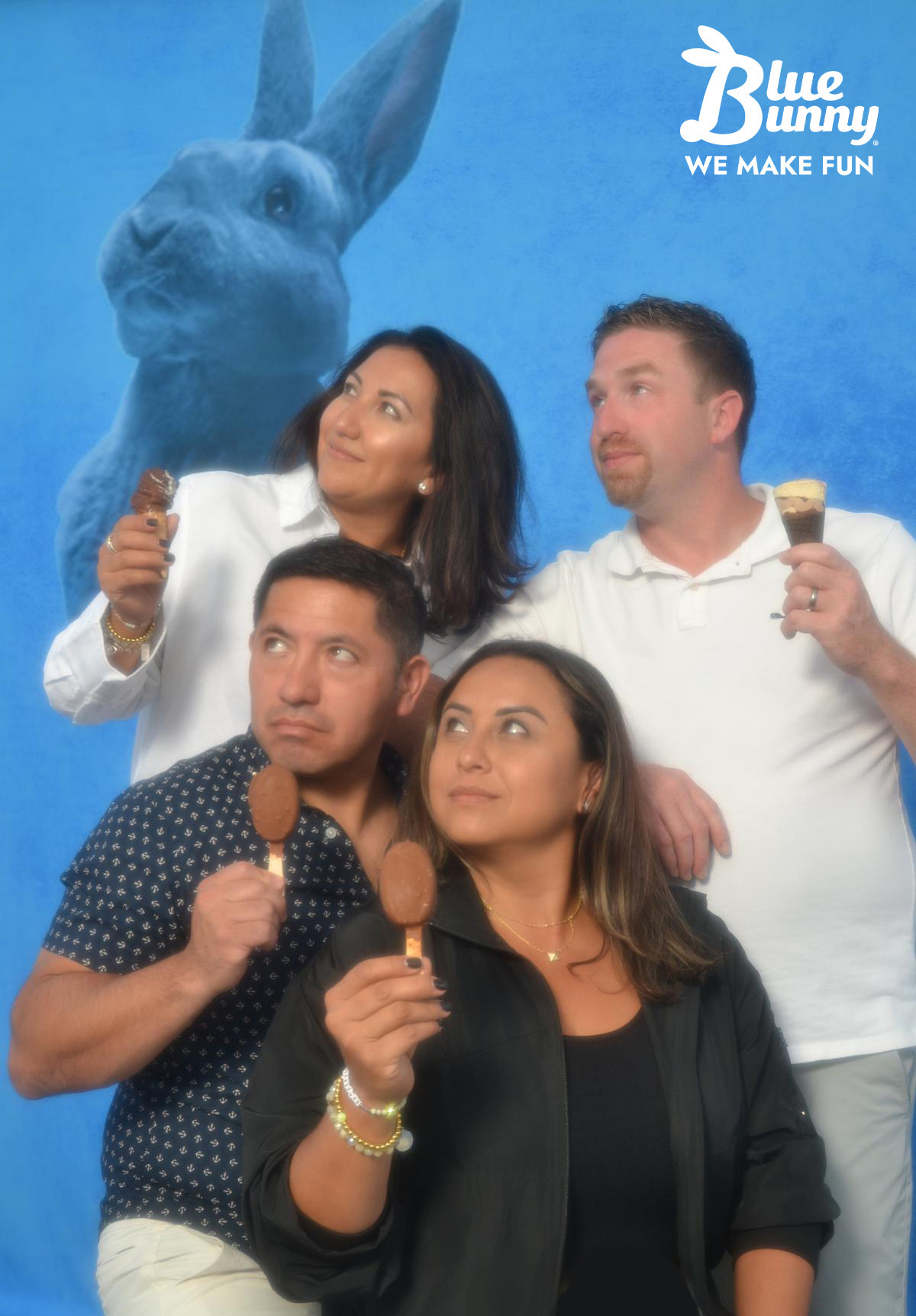 Four adults holding Blue Bunny ice cream novleties looking off into the distance