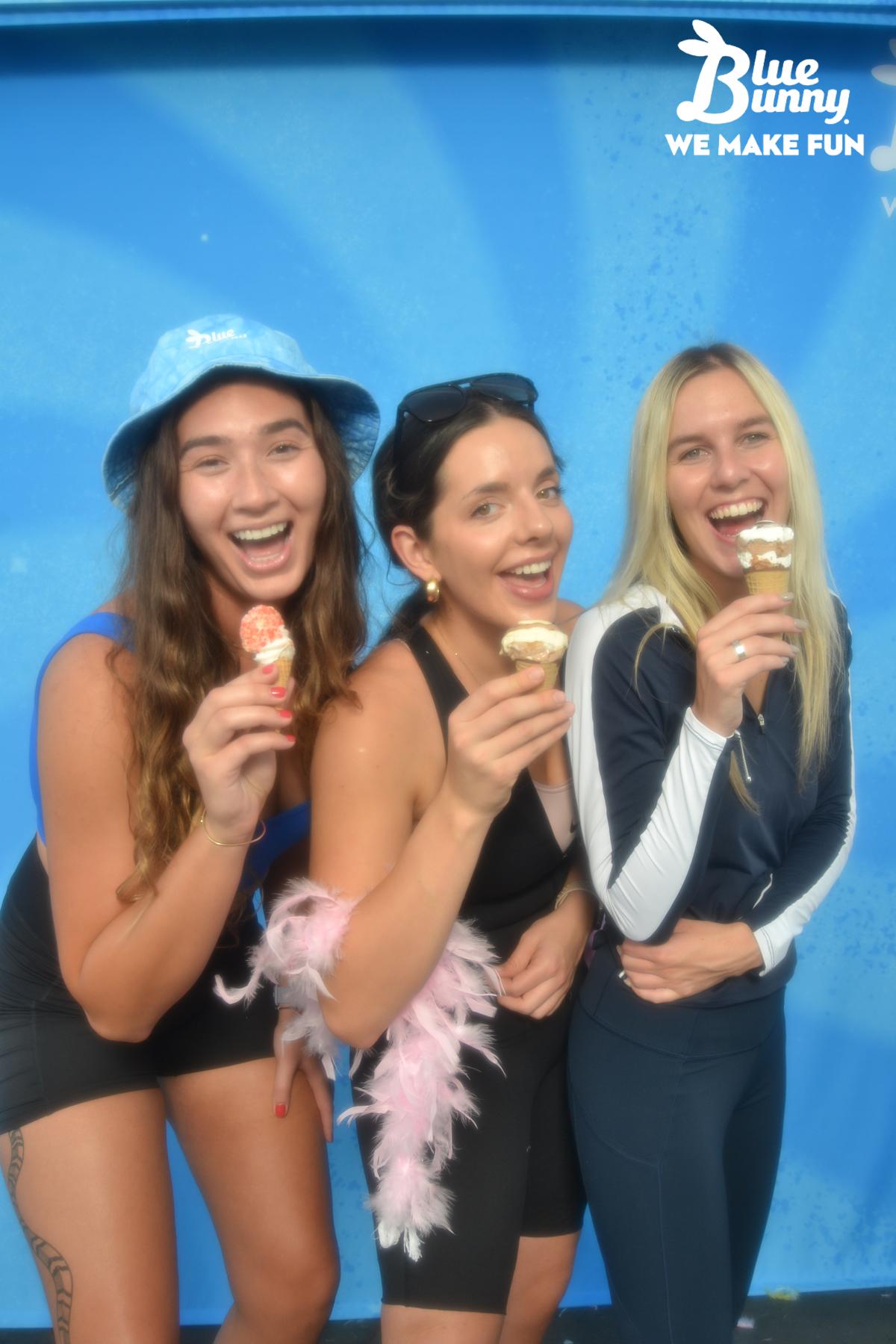 Three women leaning toward the camera with ice cream