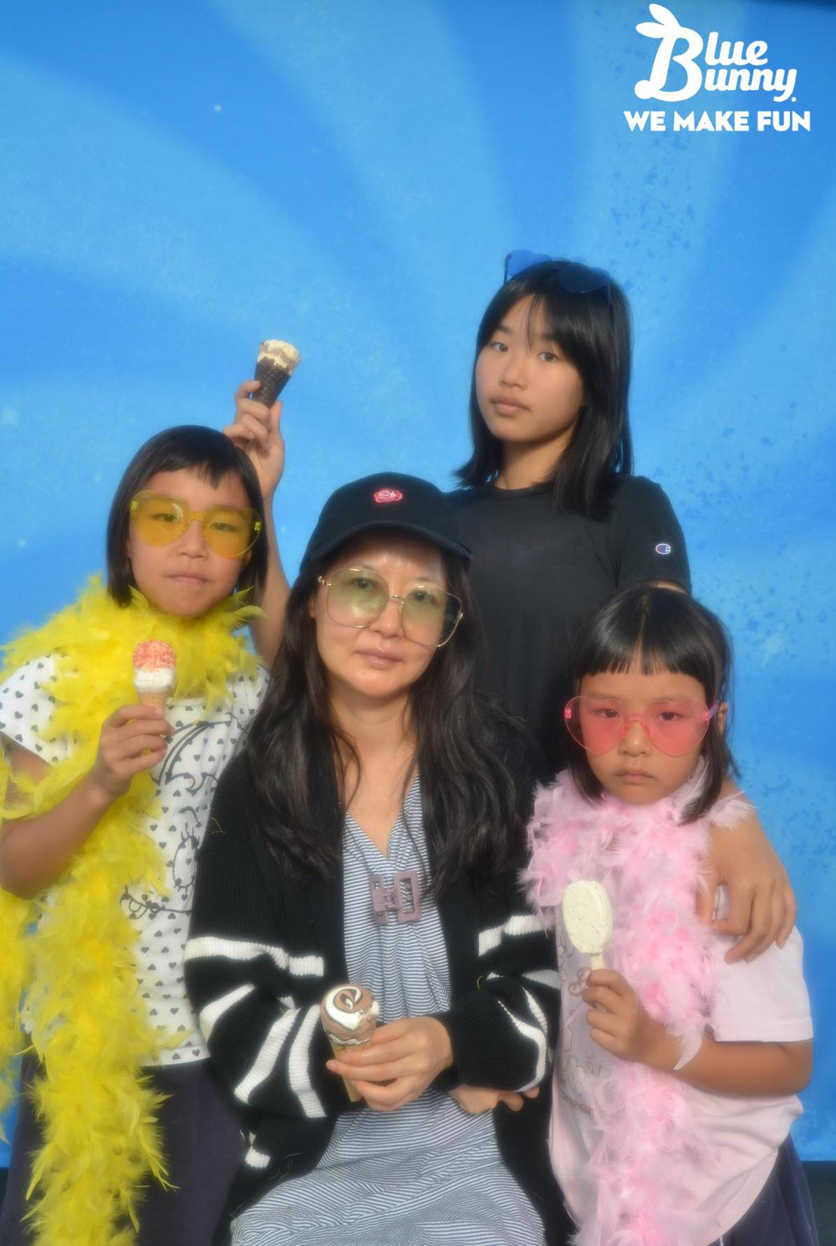 Mom with 3 daughters giving the camera serious looks while holding Blue Bunny Novelties