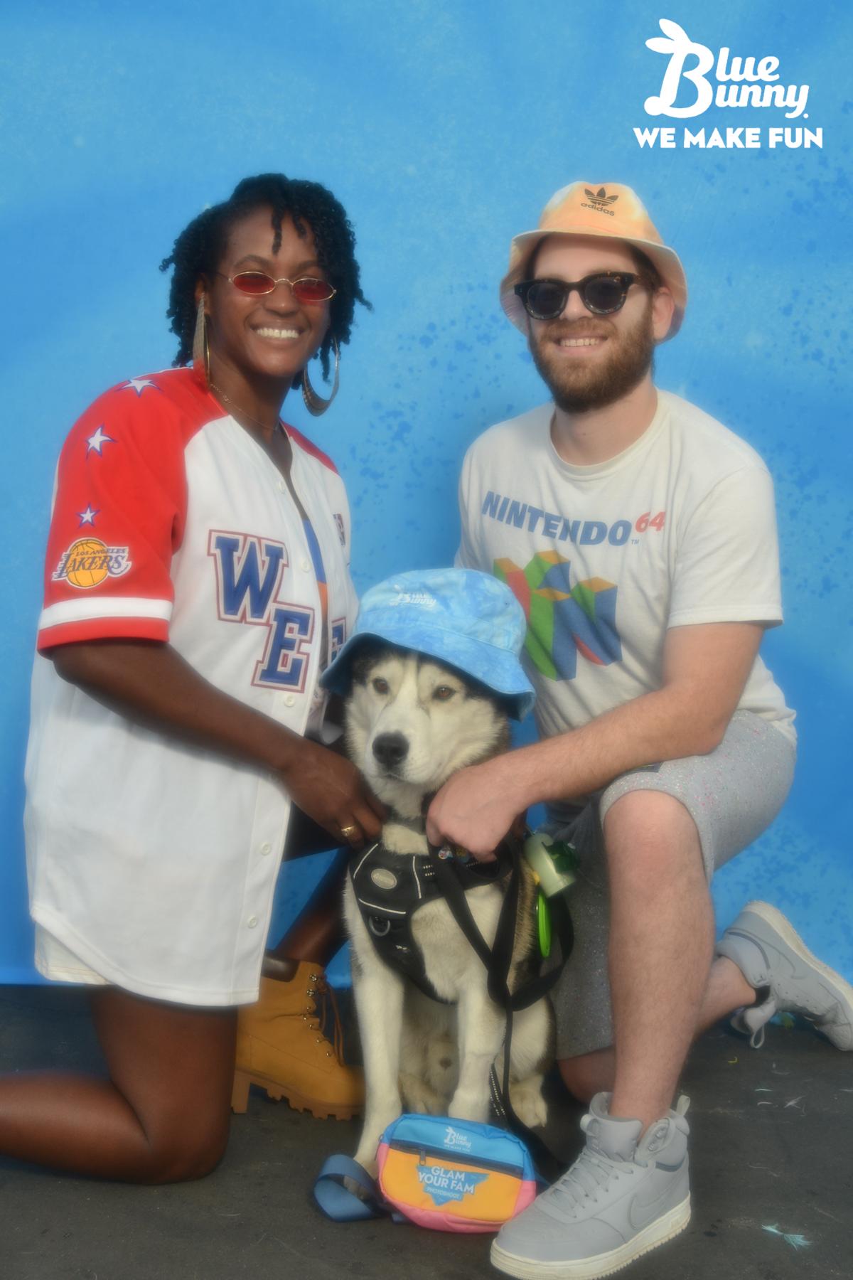 A couple with their dog wearing hats